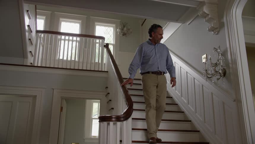 Man walks down staircase in house