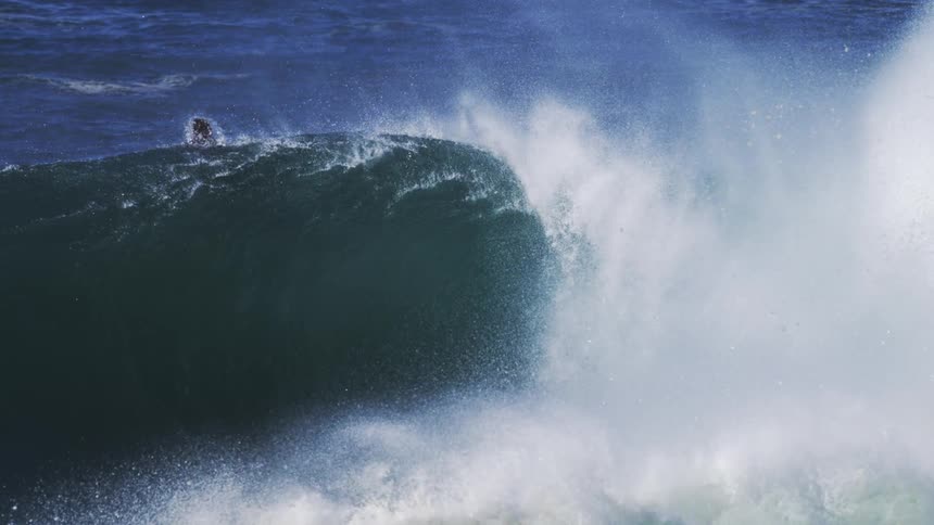 Person attempting to surf a wave