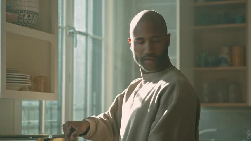 Man in kitchen serving coffee