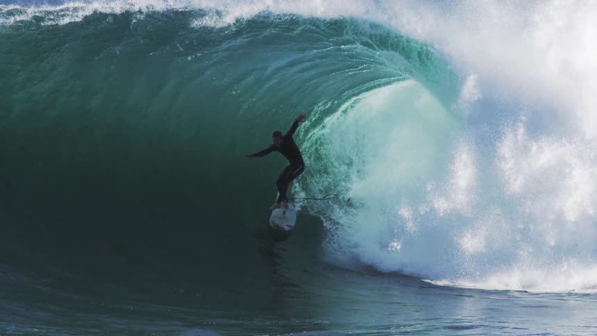 Man surfing inside a tubular wave