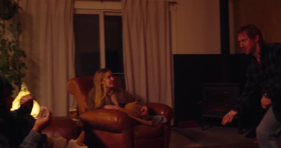 Friends in a living room with a dog playing charades