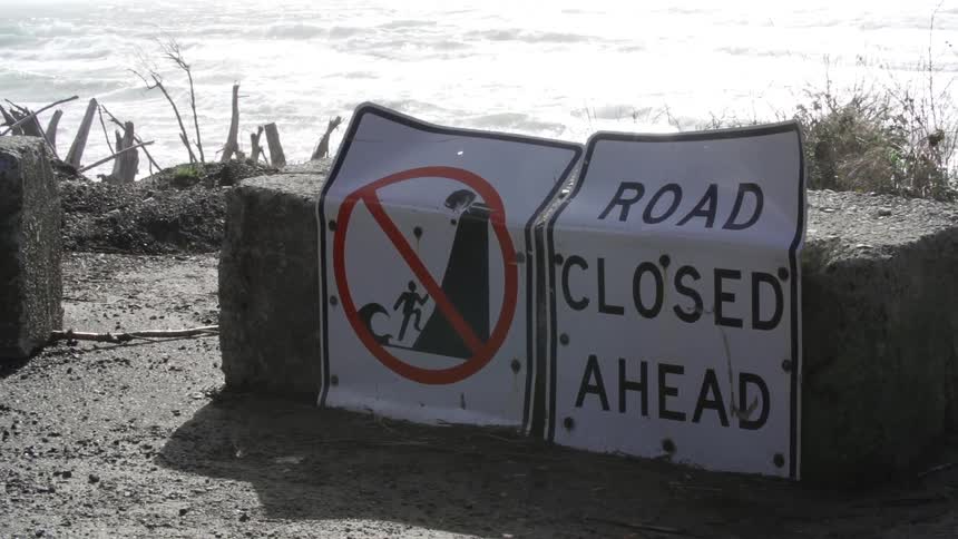 Road closed sign at a beach