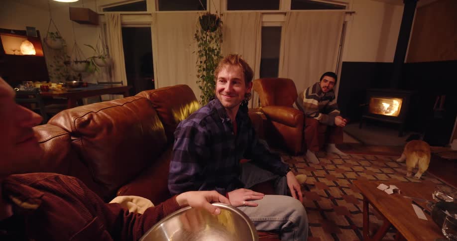 Friends in the living room eating popcorn and chatting