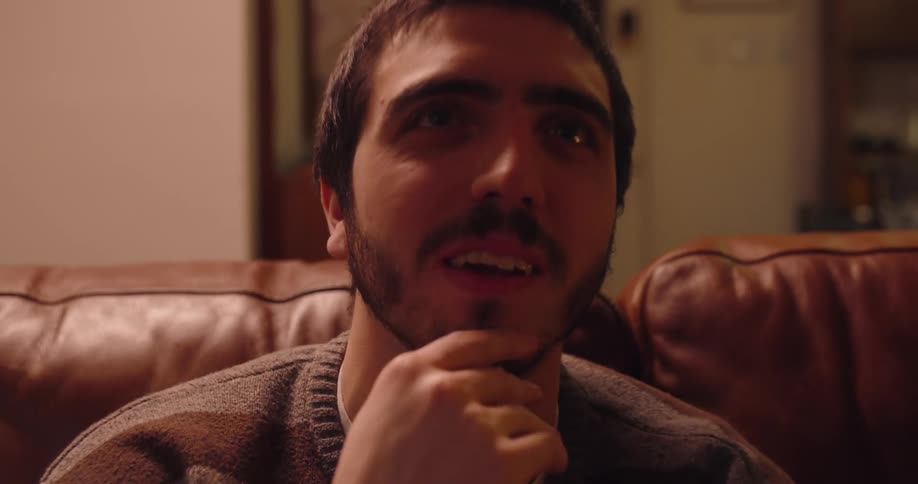 Man sitting on a sofa with a thoughtful expression