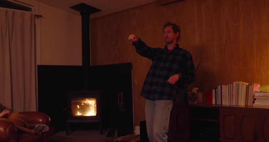 Five friends playing mime and eating popcorn in the living room
