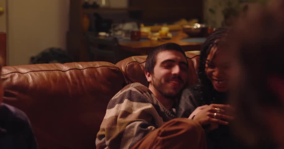 Friends in a living room clapping