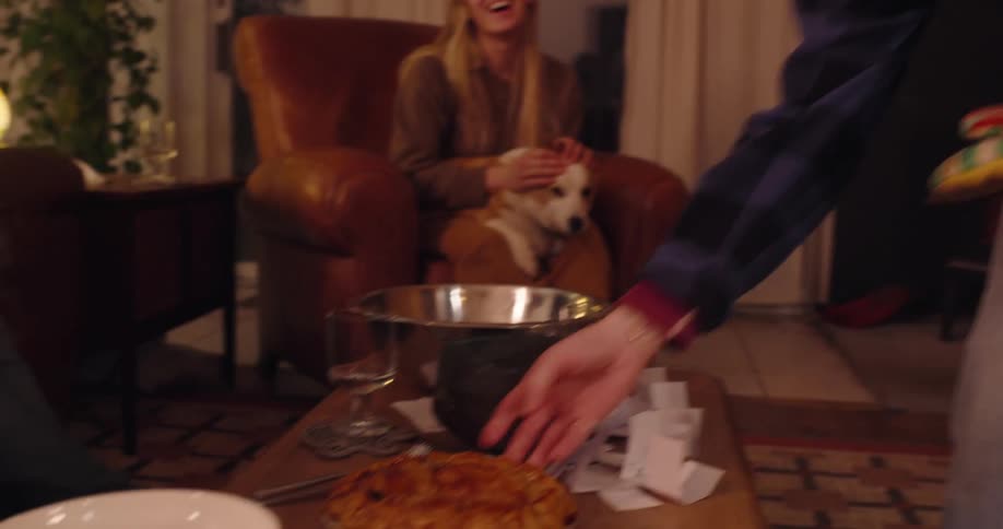 A man puts a pie on the coffee table