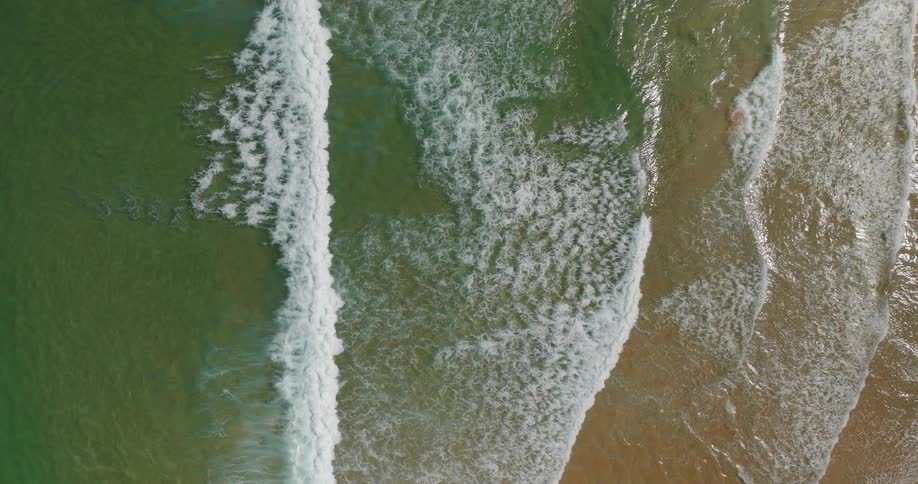 Sunlight reflects off the beach water