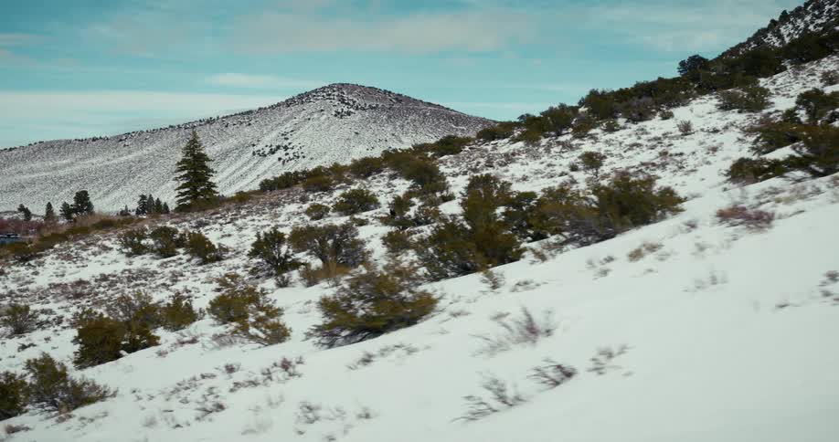 A man is skiing downhill towards the lake