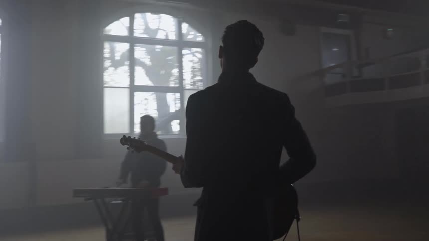 A man sings as the band performs