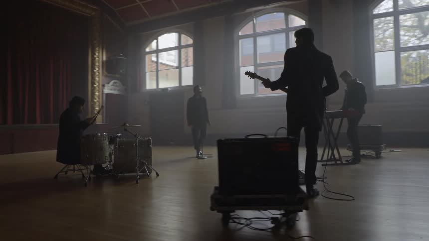 Group of four people from a musical band rehearsing
