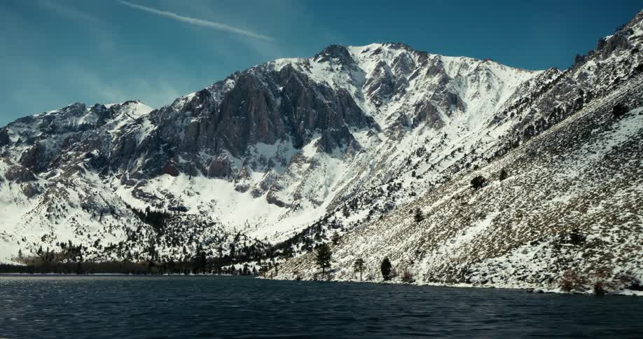 Blue lake surrounded by snowy mountains