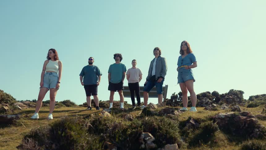 Group of people wearing jeans on a mountain outdoors