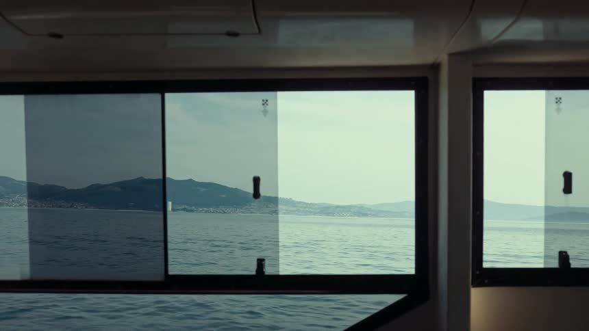 Inside view from the window of a boat moving through the ocean