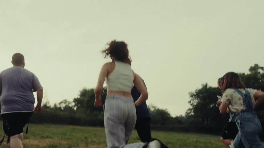 A group of people run up a hill