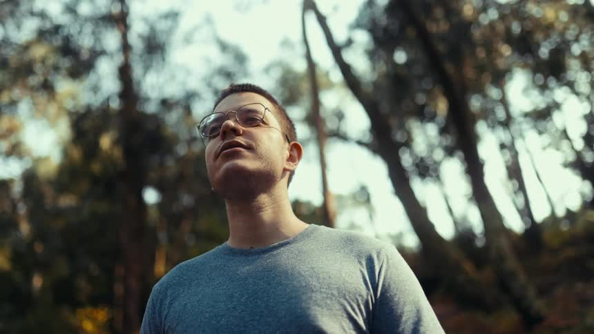 Man outdoors with trees in the background