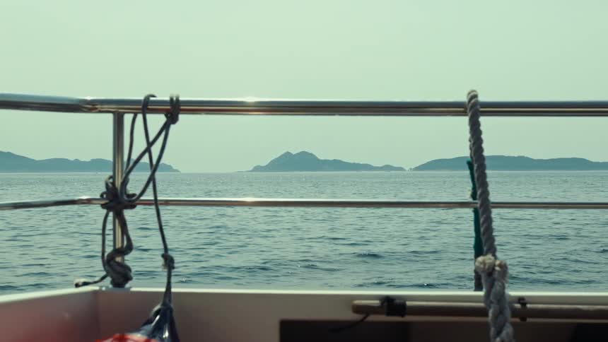 View from a boat floating on the sea a few miles from the mountains on the coast