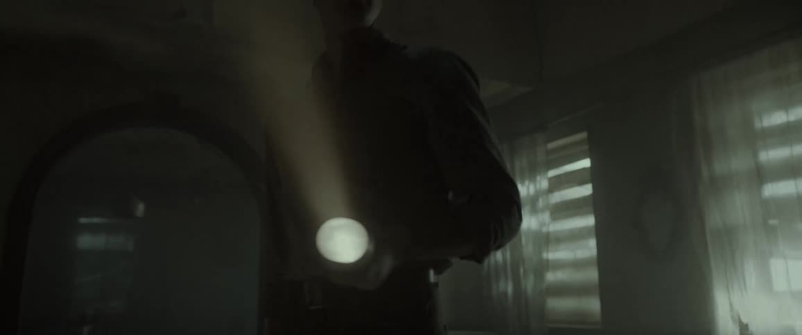 Of a man wearing a glove and holding a torch light