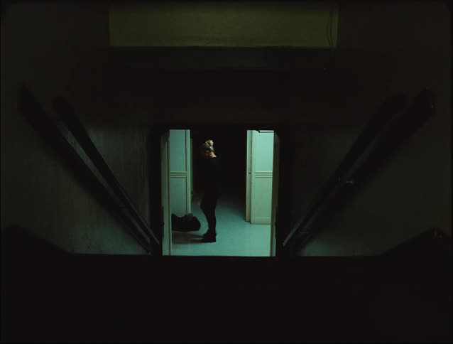 A woman is pacing the hallway down the stairs