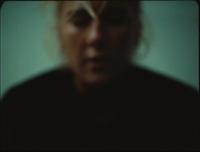 An exhausted woman sweating and leaning against the wall to rest