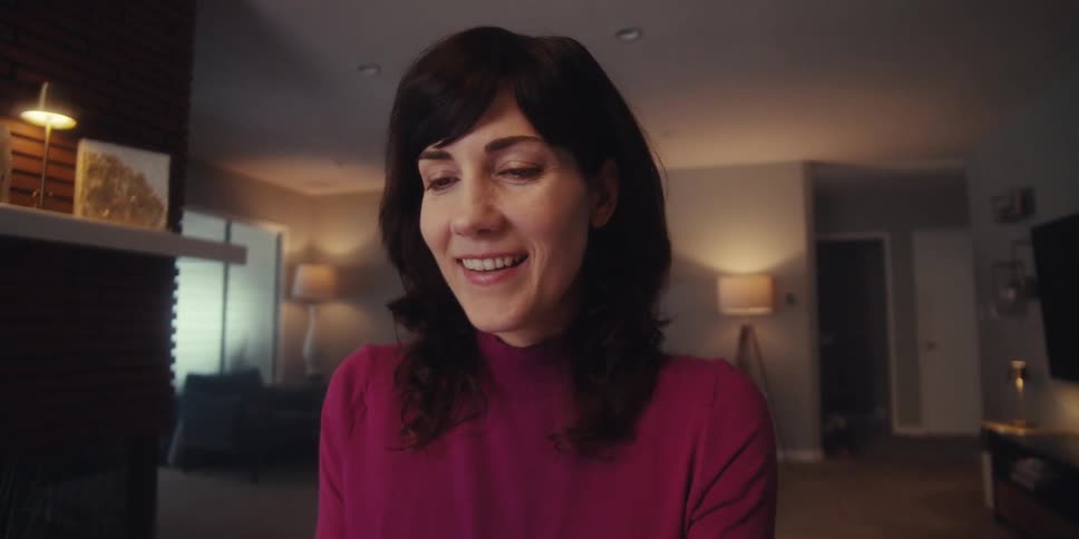 Woman sitting at a table with happy facial expression