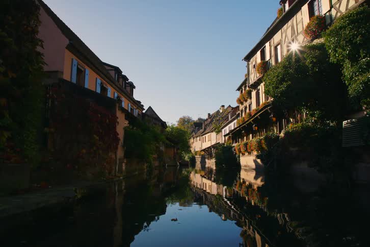 Narrow river channel surrounded by houses with classical architecture