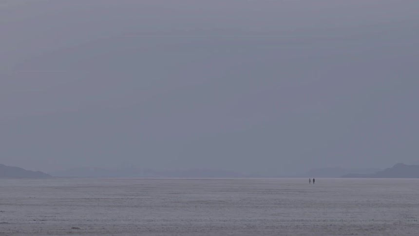 Two people barely visible walking