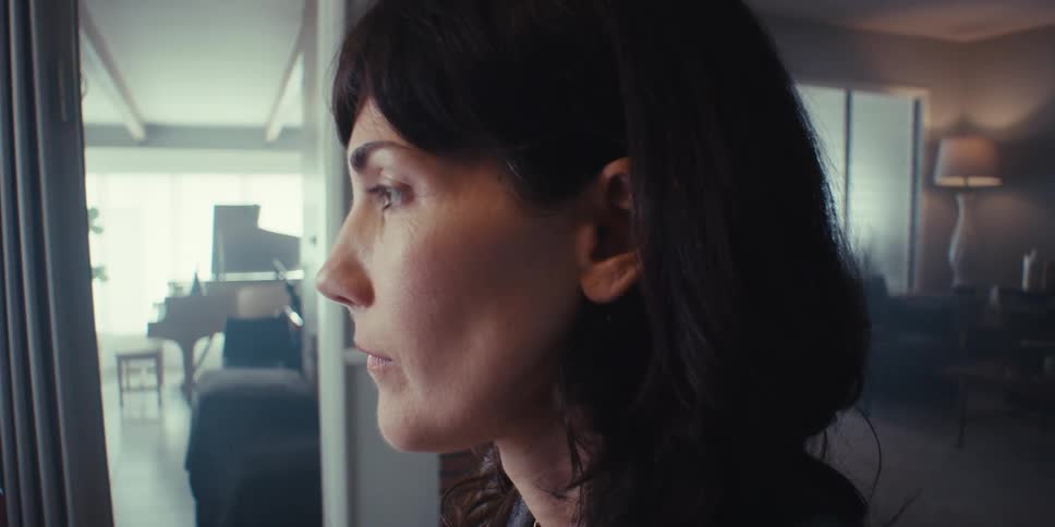 A woman blinks her eyes looking forward