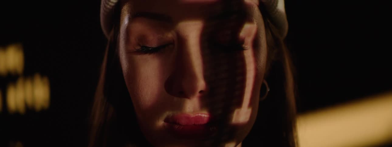 The projector image flashes on the womans face