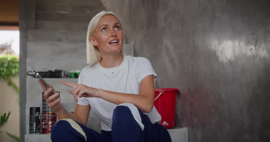 A footage of a lady operating a smartphone and having a discussion while sitting