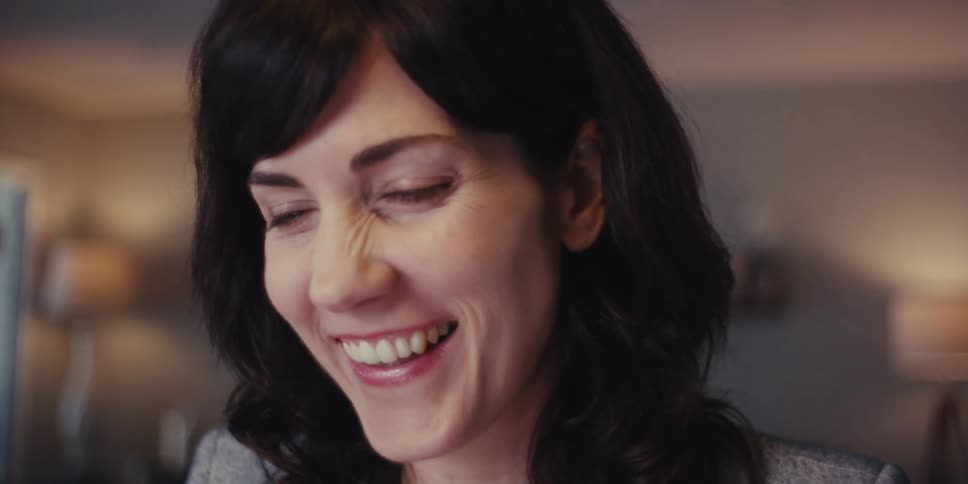 A woman laughs and talks