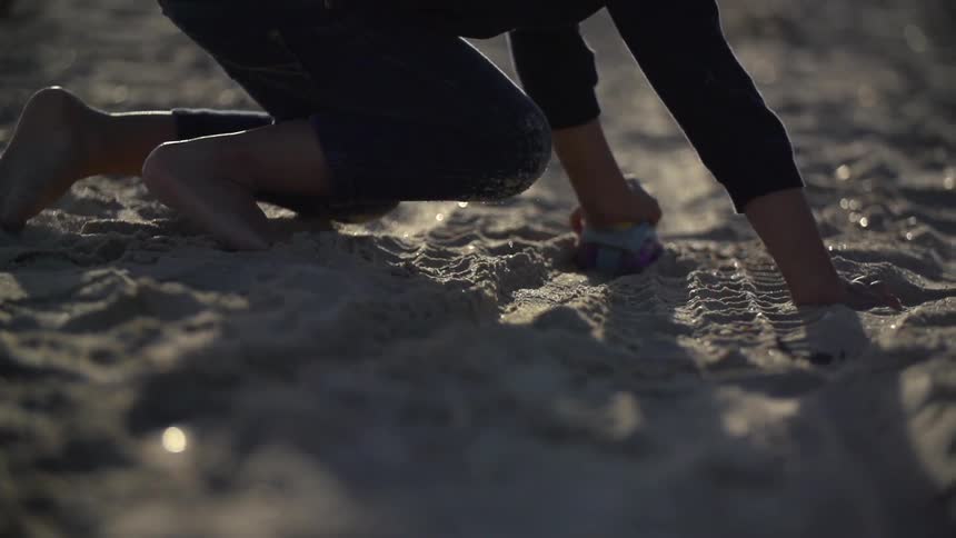 A person crawling round in the sand