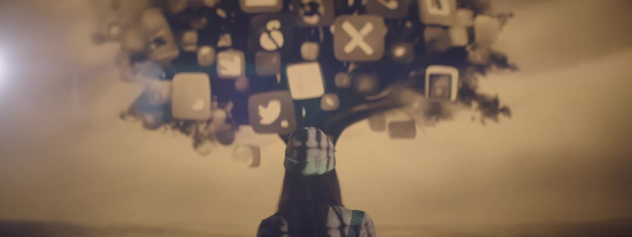 Woman in a cap facing a screen