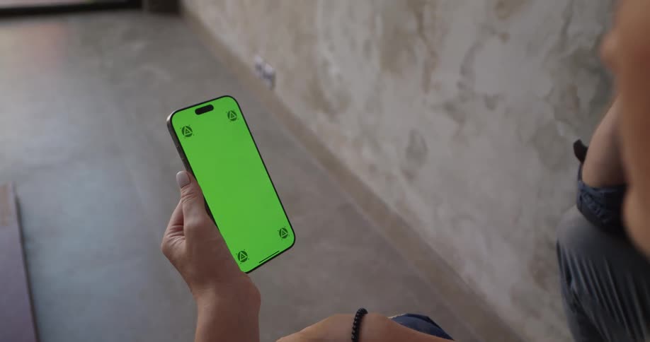 A woman is holding up her cell phone