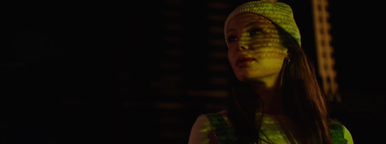 Woman with a white cap on her head facing a screen with no signal