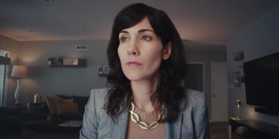 A woman sitting at a desk is thinking about something looking sad
