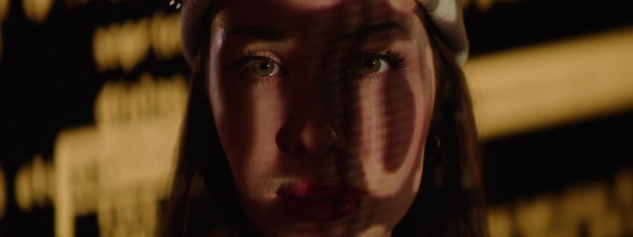 Portrait of a young woman with a play of lights on her face
