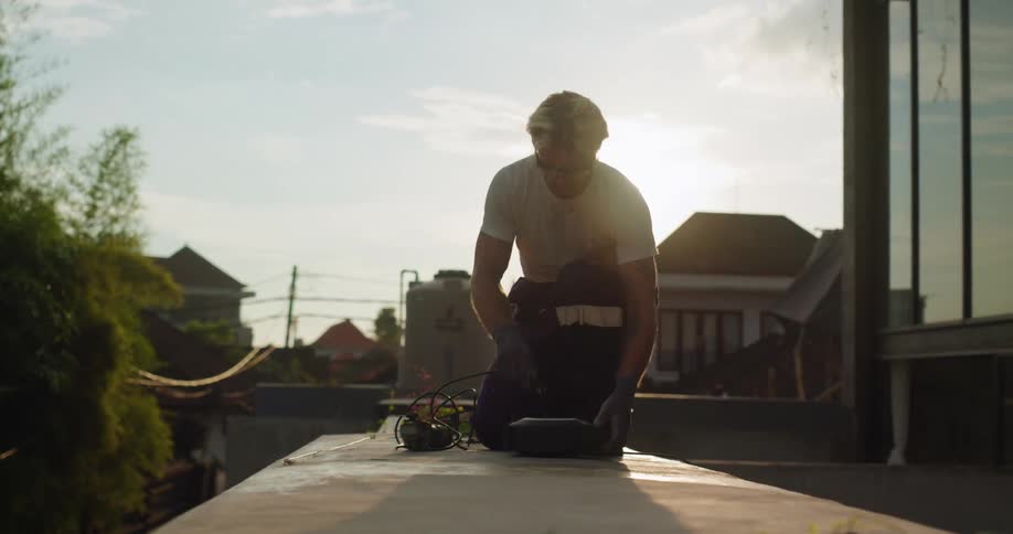 Man with protective glasses turning on a tool