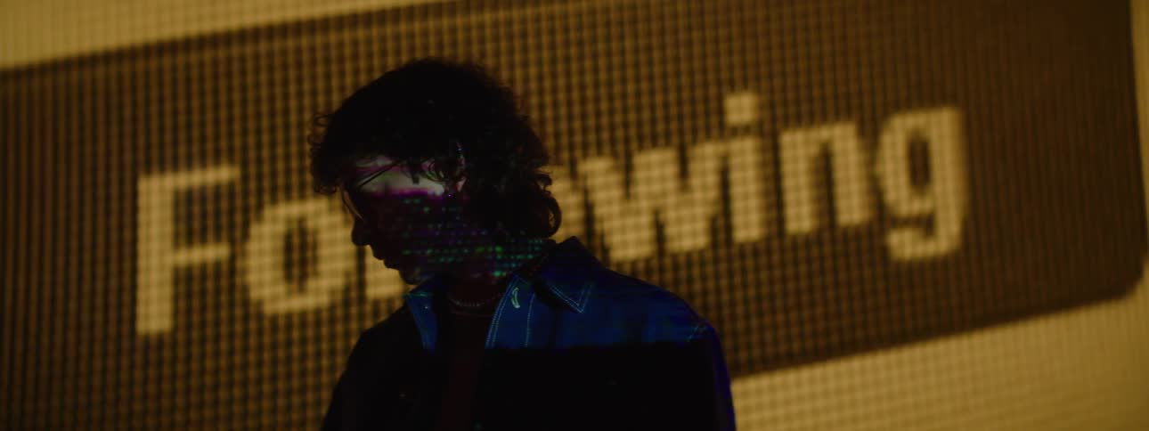 A close up footage of a person standing in front of a screen