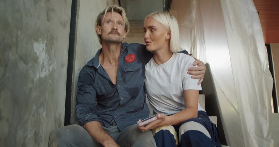 Couple sitting on a staircase laughing