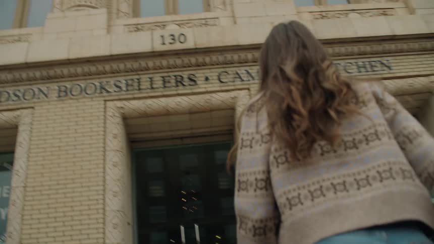 A woman walks to enter the bookstore