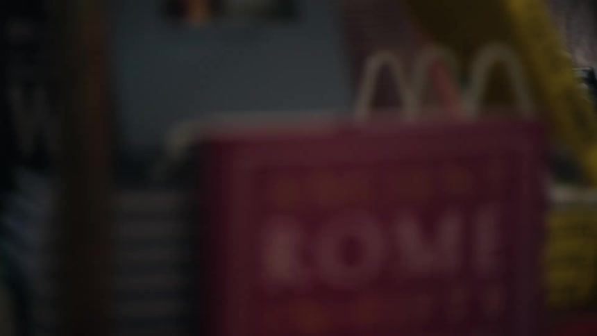 A lady opens a book cover after touching different books in a bookstore