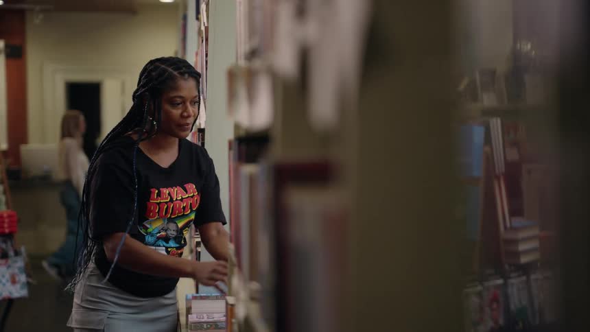 A woman is searching for a book in a book store