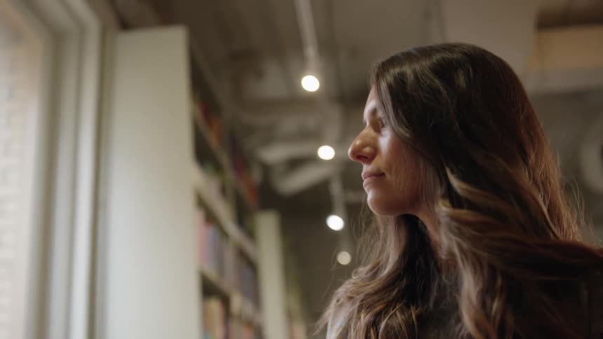 The woman is shopping and looking at all the books