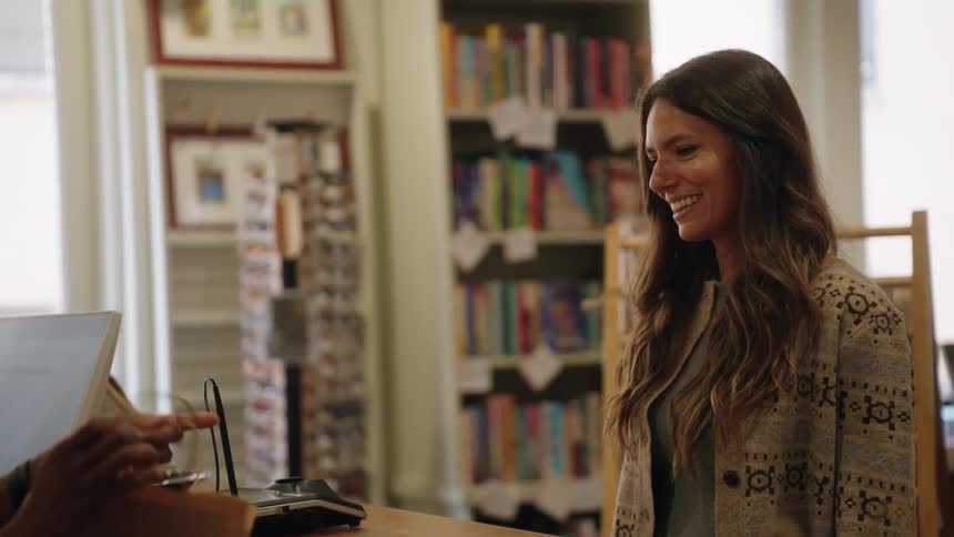 Woman purchasing book