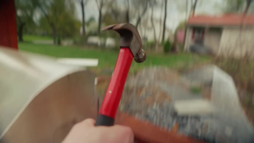 A person is hammering in a nail