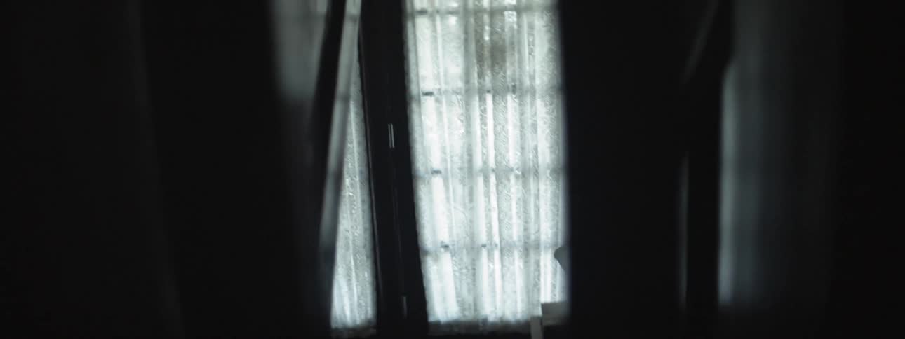 A woman runs down the stairs and exits the house