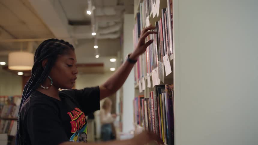 Woman organizing books in a bookstore