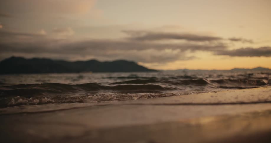 Ocean waves roll onto the sandy beach