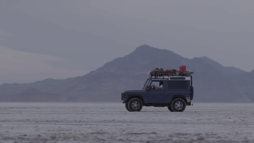 A jeep travels through the desert